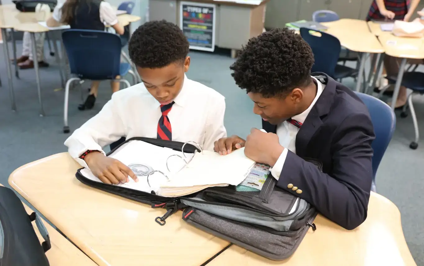 two boys studying togetheron page image
