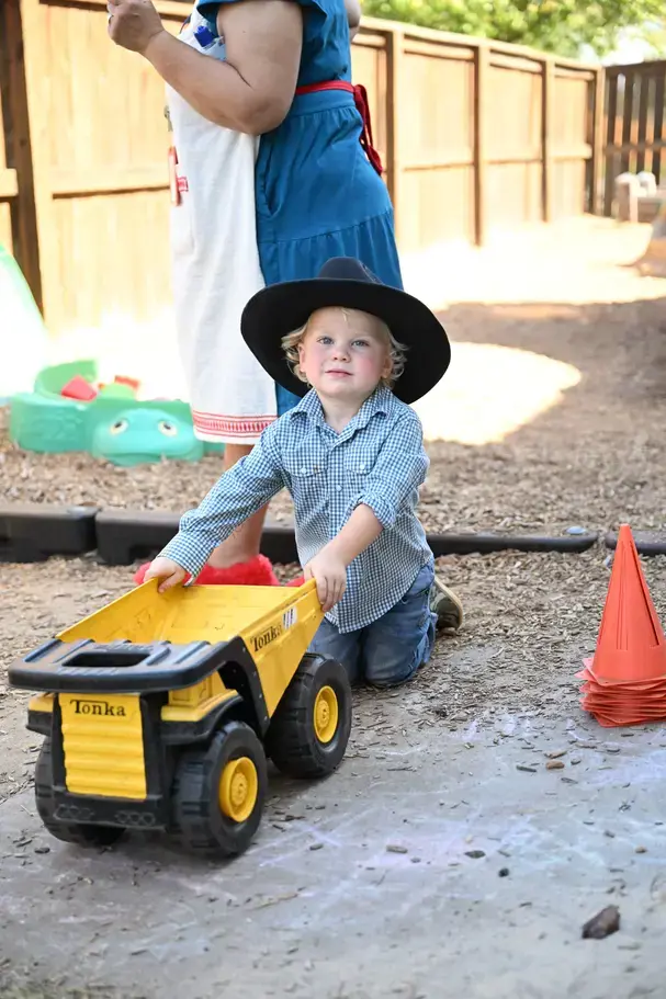 preschool boy playing with toy caron page image