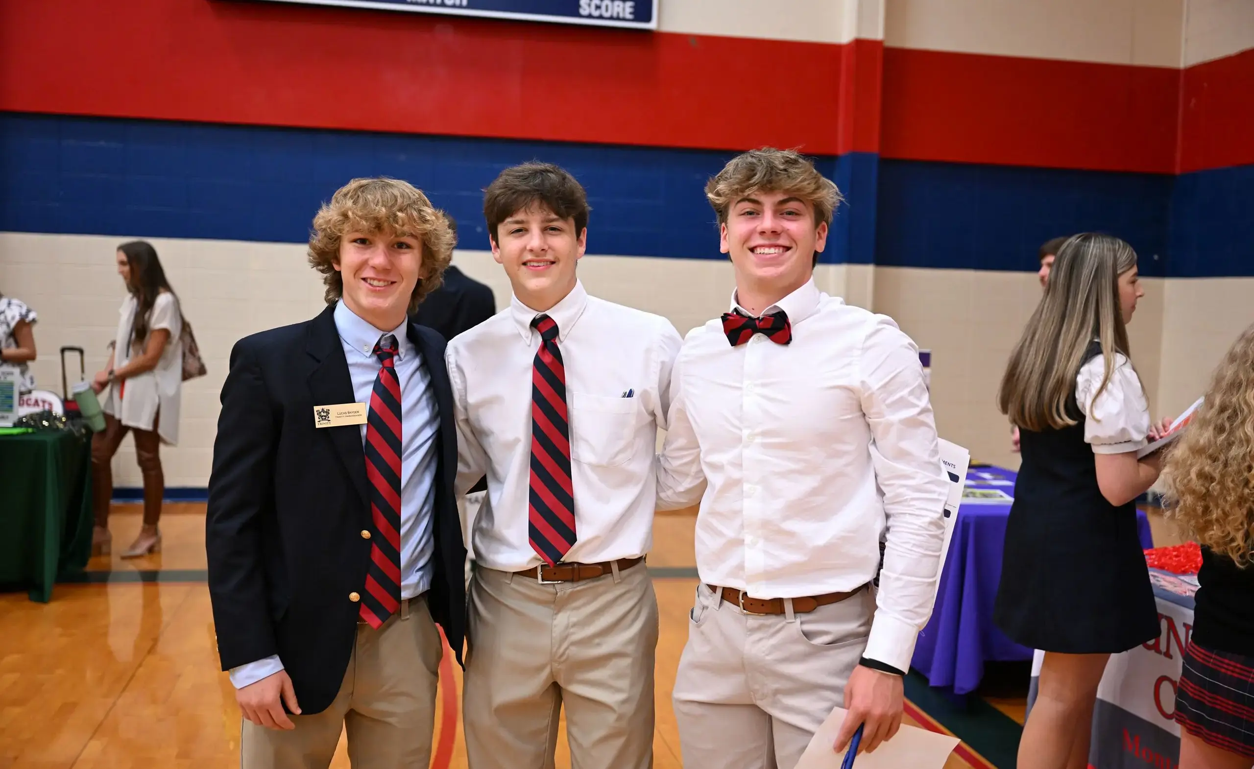 three guys in uniforms at college day