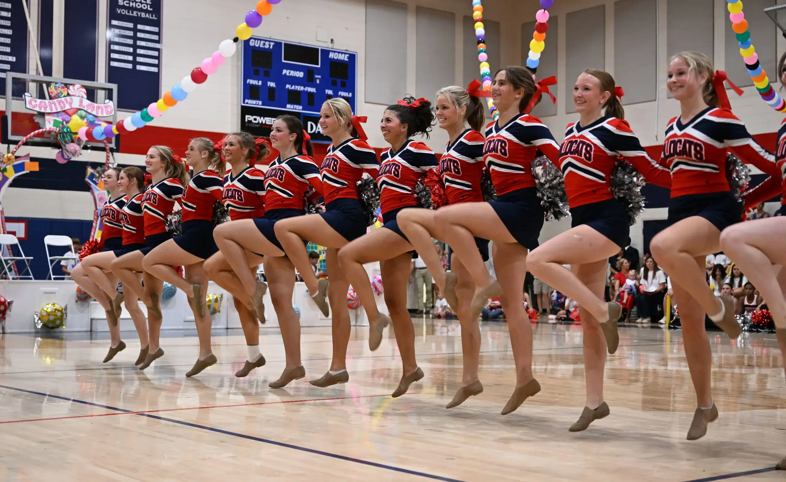 Dancers executing group high kick