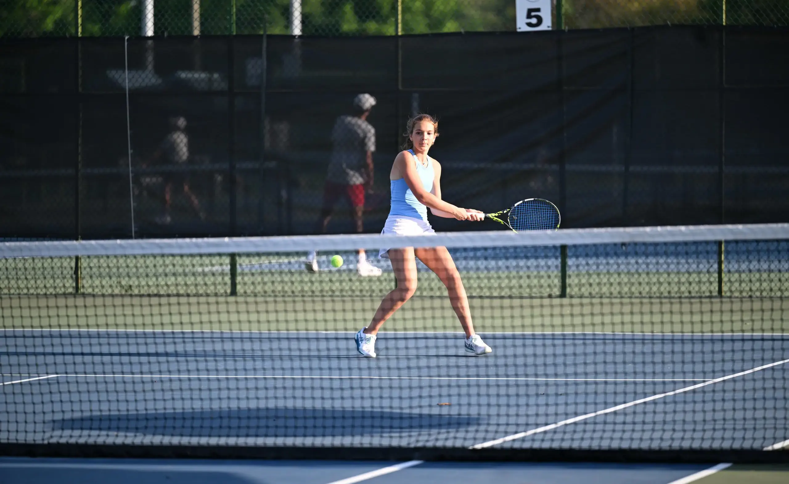 Student athlete playing tennis